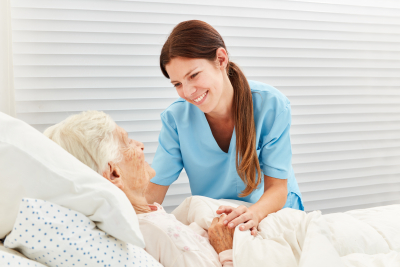 caring nurse cares for ill senior citizen in nursing home