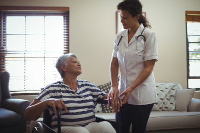 caregiver interacting with senior woman on wheelchair